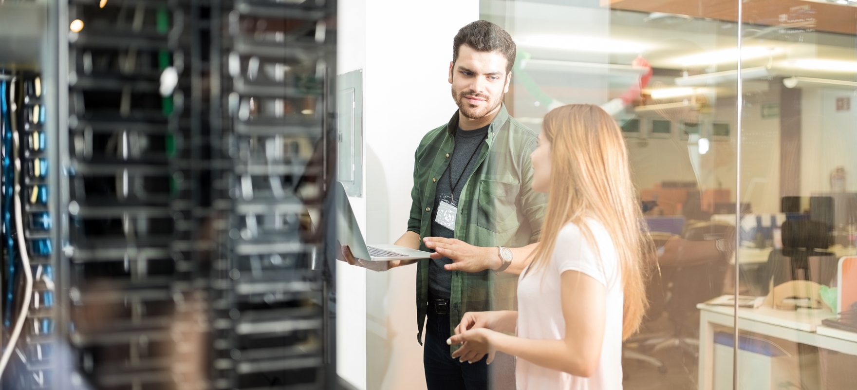 Colleagues discussing in office server room